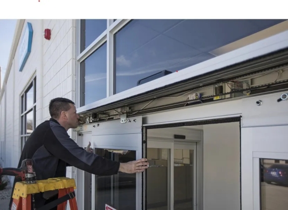 Technician performing automatic door repair in Grand Junction