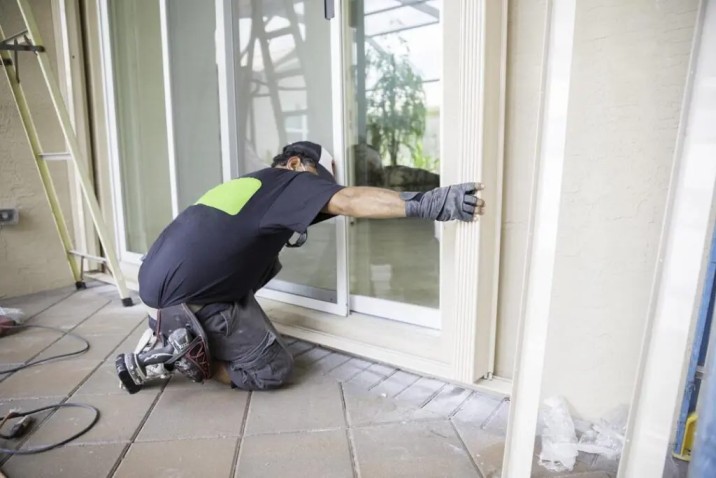 Technician performing glass door repair in a Grand Junction home