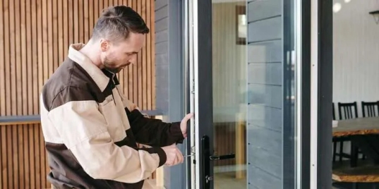 Technician repairing storefront door dragging in Grand Junction