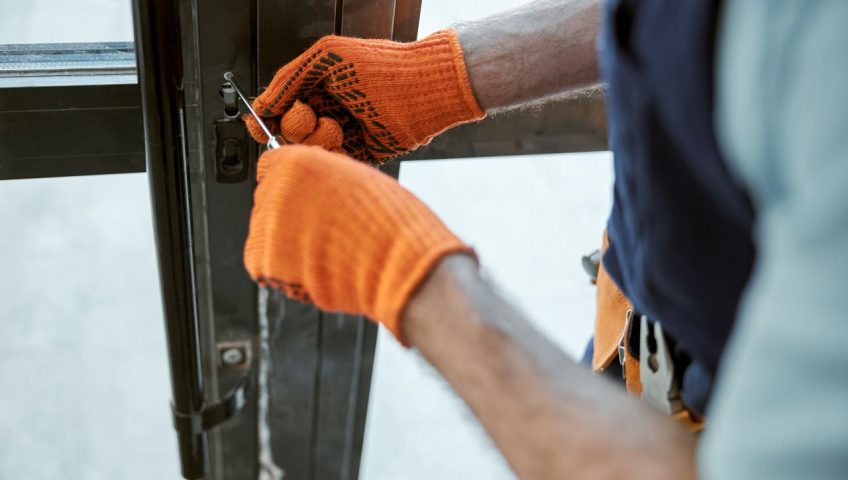 Technician repairing a commercial door in Grand Junction business
