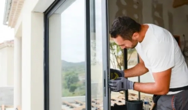 Technician performing sliding glass door repair in Grand Junction home