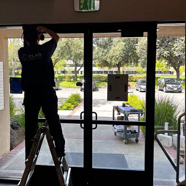 Technician repairing storefront door dragging in Glenwood Springs business
