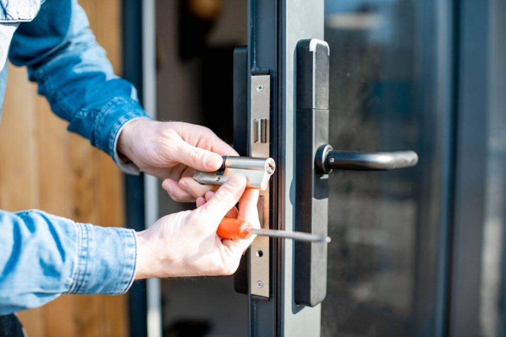 Technician fixing storefront door not locking in Glenwood Springs