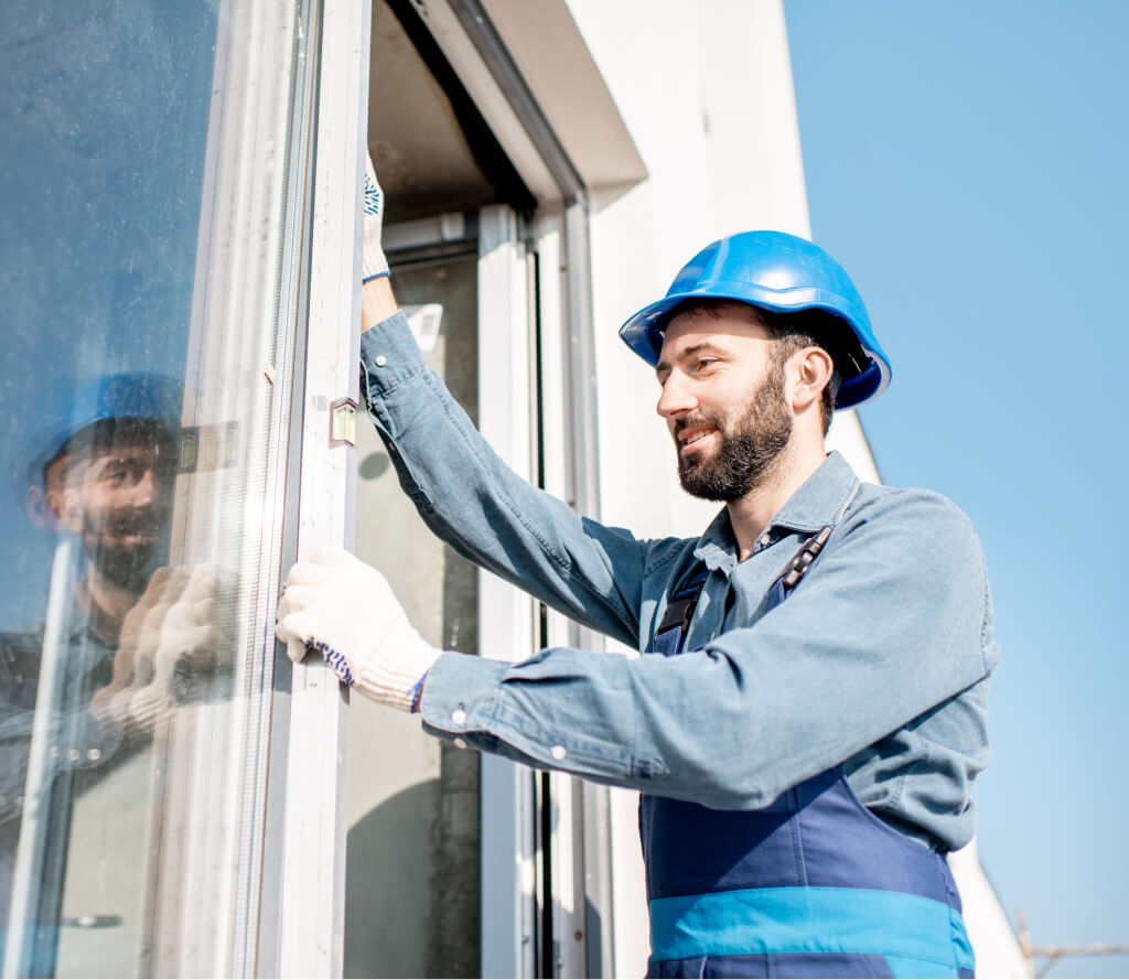 Technician installing custom cut window glass in Grand Junction