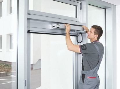 Technician performing door maintenance on a residential door in Rifle