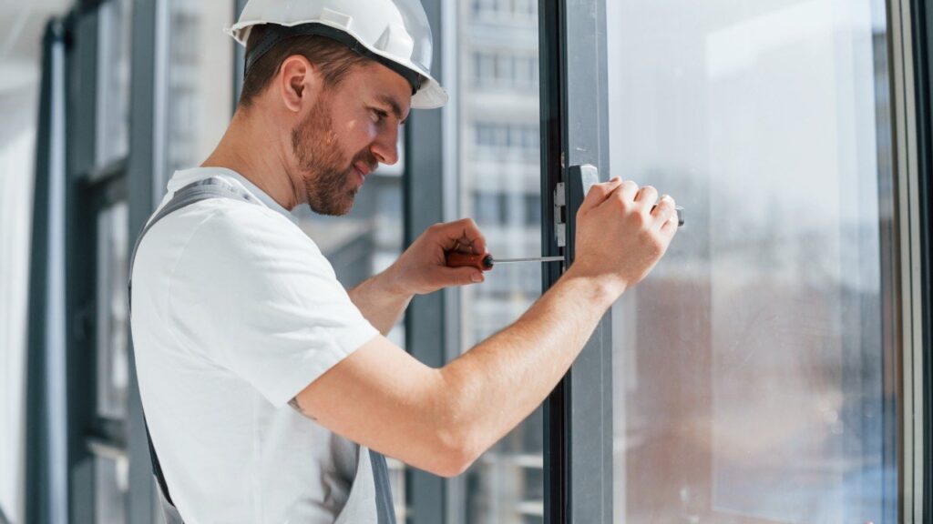 Technician repairing commercial window in Grand Junction Colorado