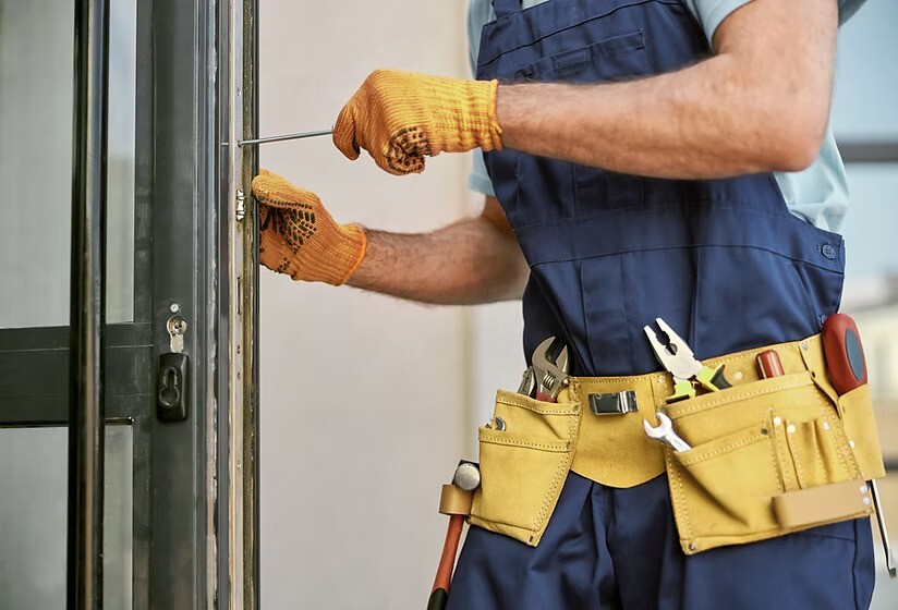 Professional door repair expert servicing a door in Grand Junction