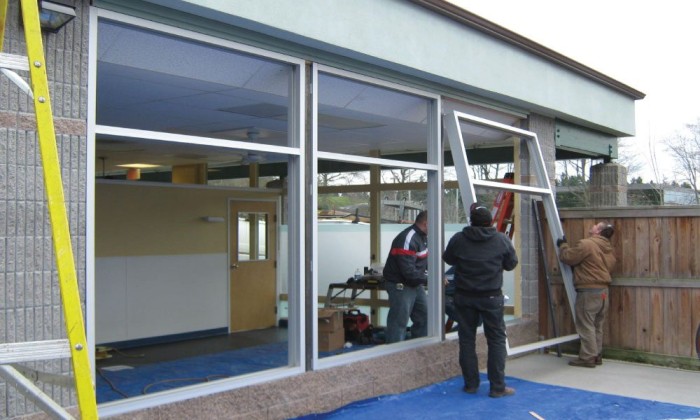 Technician installing commercial storefront glass in Grand Junction
